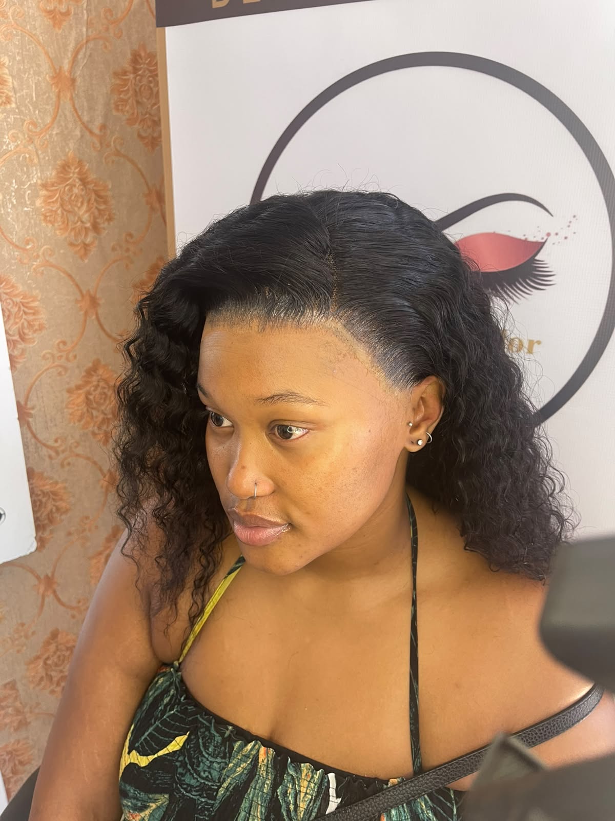 Finished curly lace wig install with a side part and a natural-looking hairline