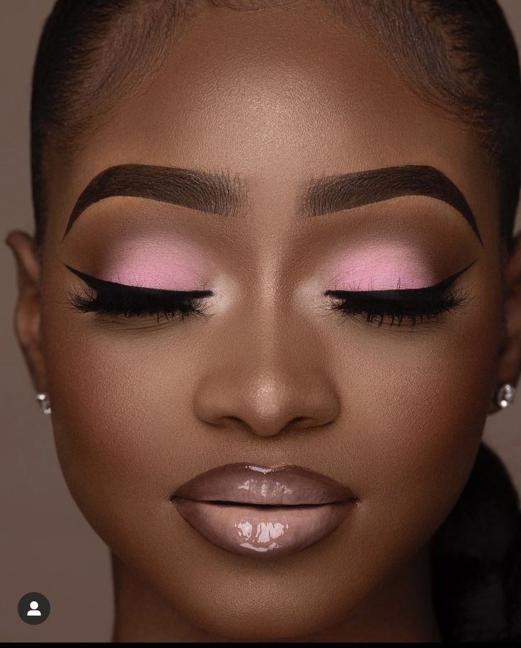 Soft glam with pink eyeshadow, winged liner, full lashes and a glossy nude lip