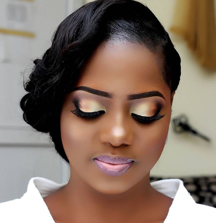 Side-swept updo with gold soft glam eyes and full lashes
