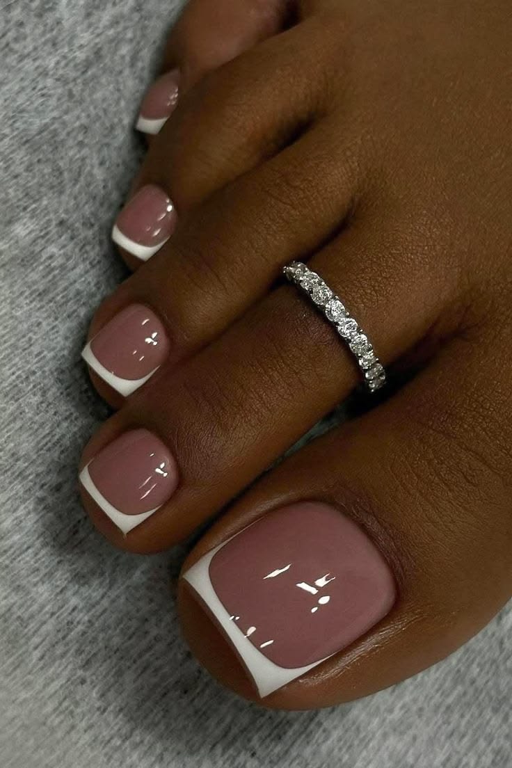 Toes in mauve gel with white French tips and a diamond toe ring