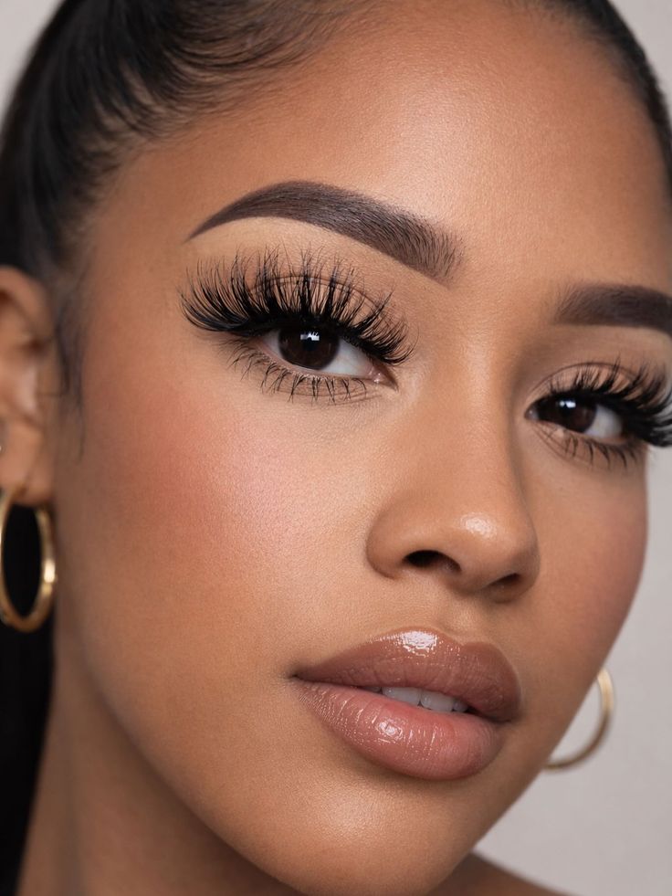 Fluffy lashes, sculpted brows and a glossy brown lip
