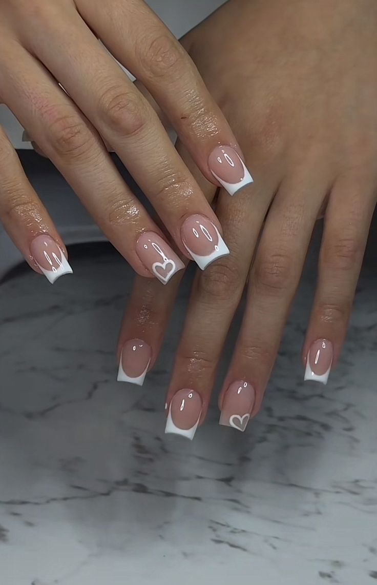 Short square French tips with small white heart details